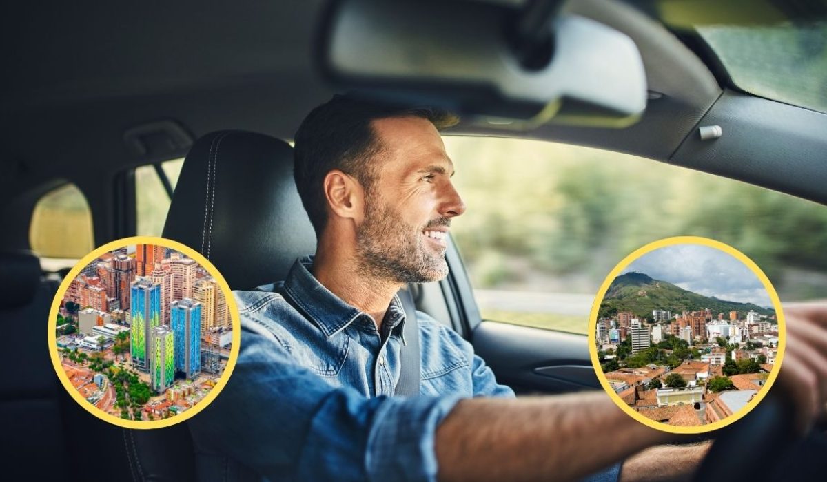 Hombre conduciendo sonriente su carro. Ciudad de Bogotá y de Cali