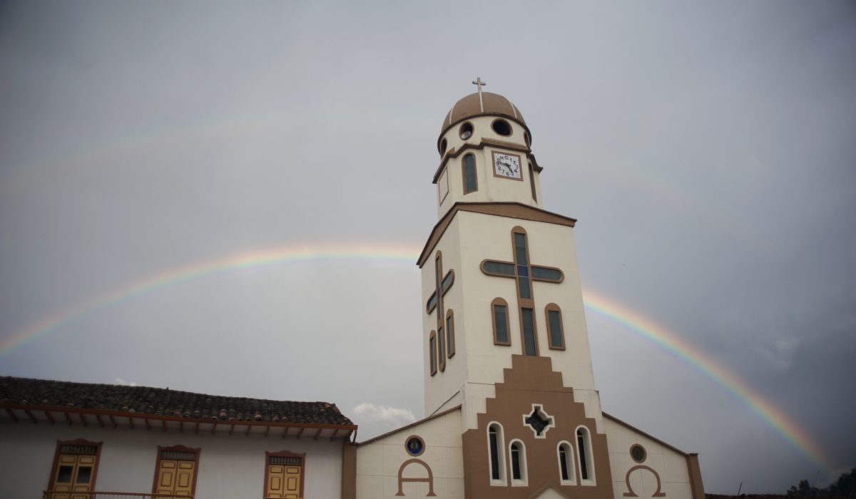 Senora del Carmen Church with a double rainbow behind.